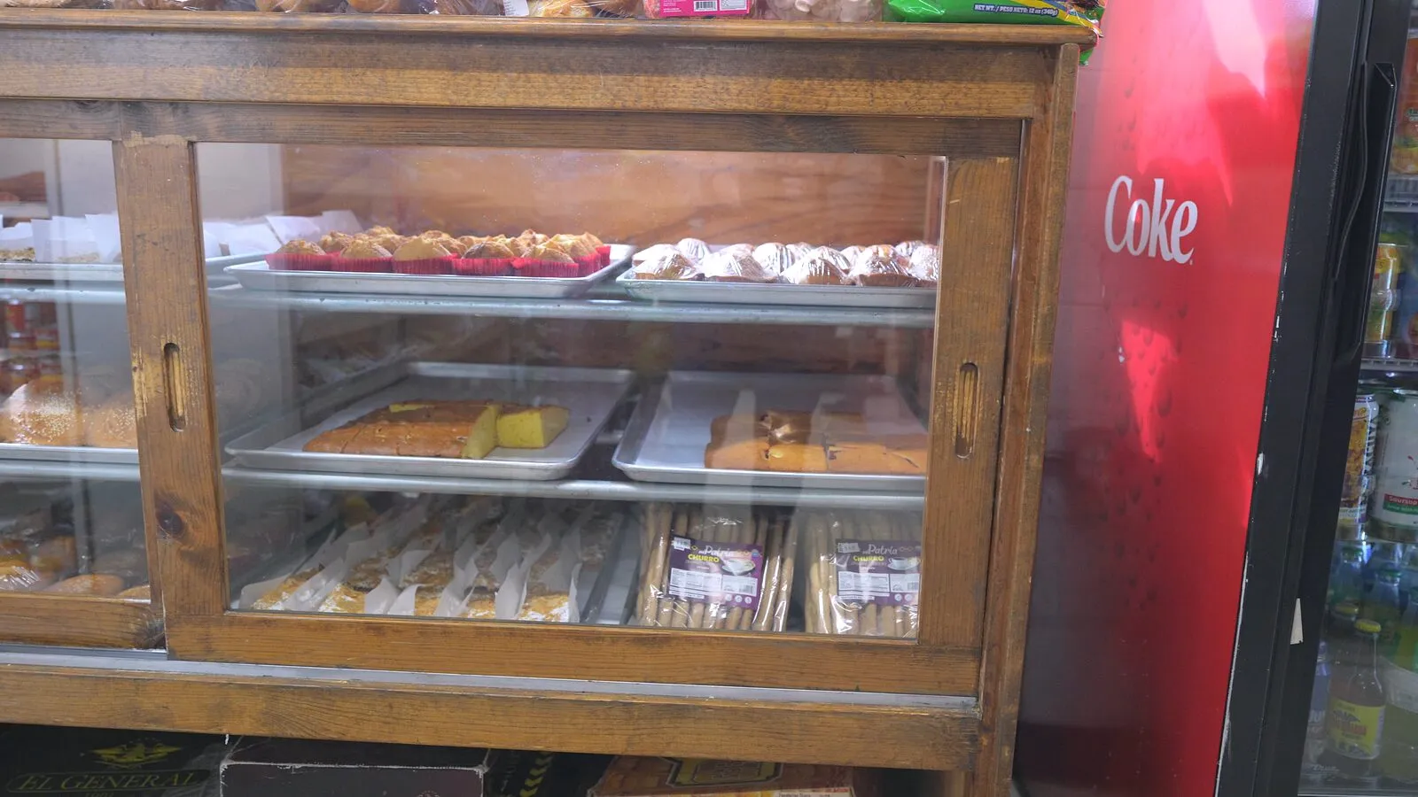 The bakery counter: pan dulce and bolillos in the wooden display case